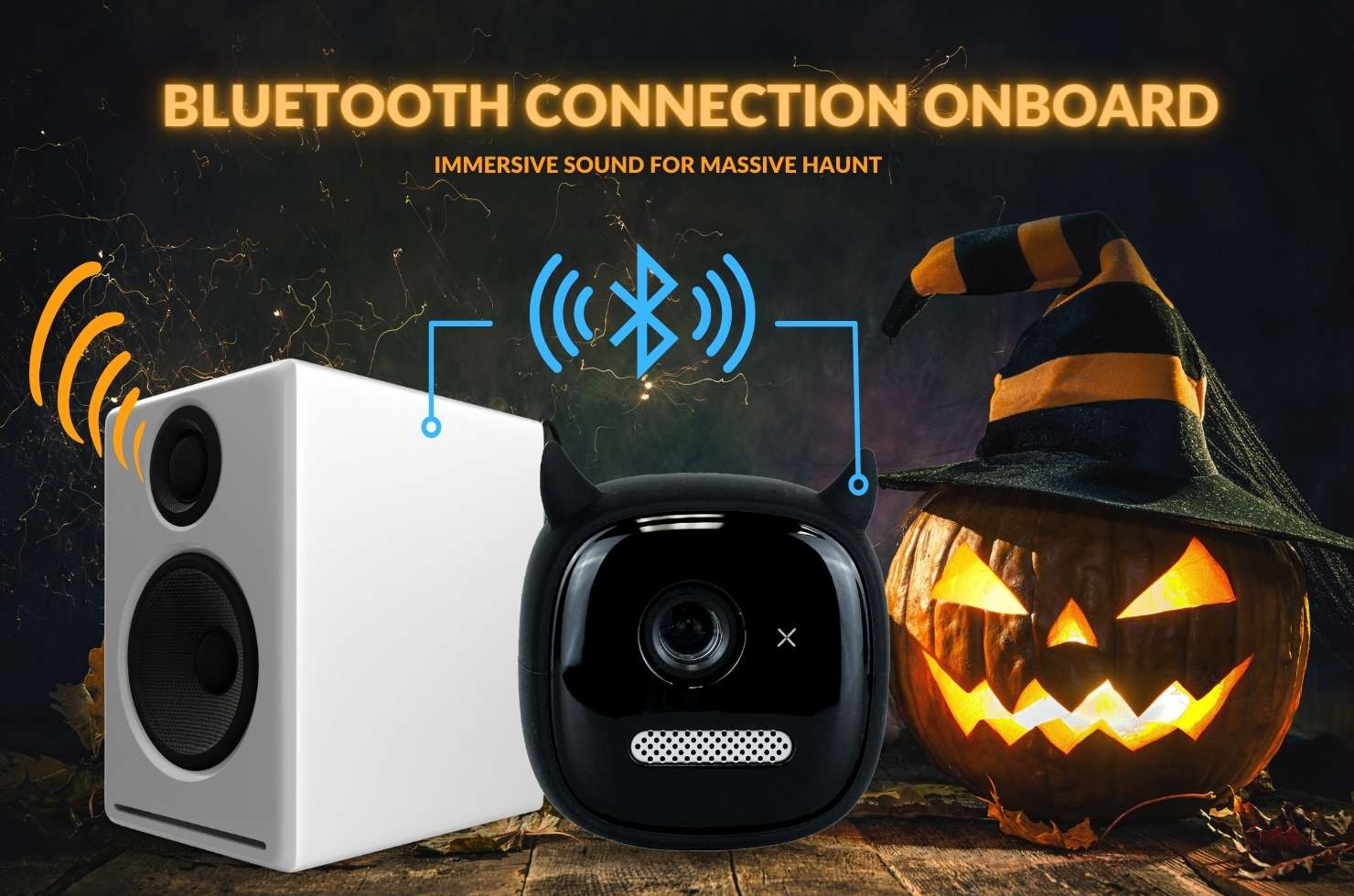 HP2 in between a bluetooth speaker and jack-o-lantern; connected to speaker via bluetooth